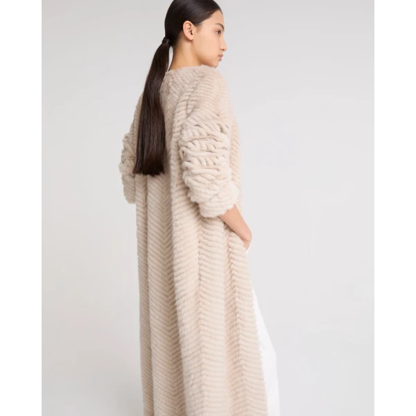 Woman wearing Yves Salomon shearling fur coat – luxury outerwear at Coveti