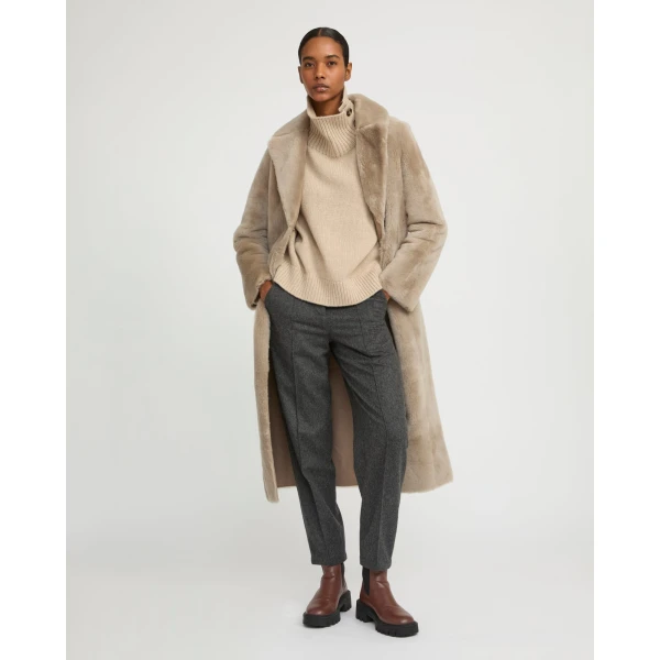Woman wearing Yves Salomon shearling fur coat – luxury outerwear at Coveti