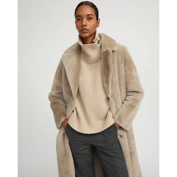 Woman wearing Yves Salomon shearling fur coat – luxury outerwear at Coveti