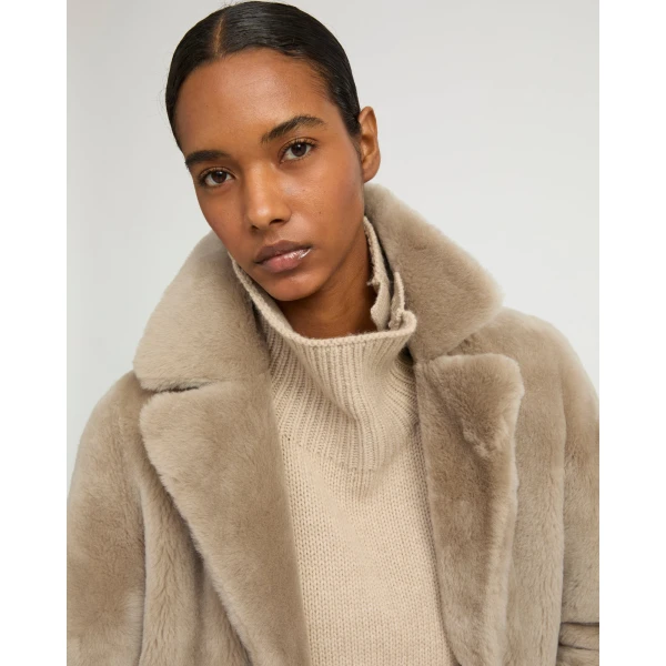 Woman wearing Yves Salomon shearling fur coat – luxury outerwear at Coveti