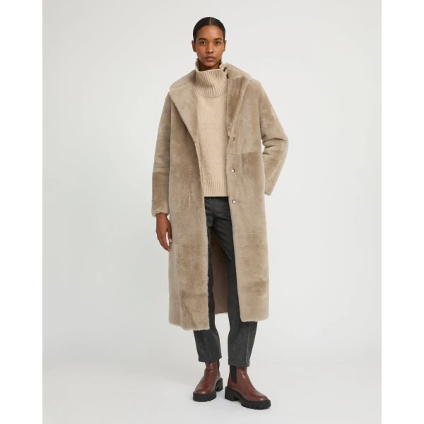 Woman wearing Yves Salomon shearling fur coat – luxury outerwear at Coveti