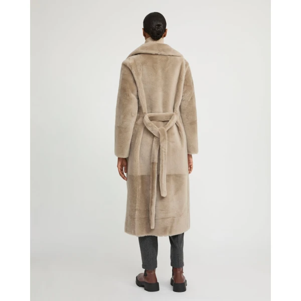 Woman wearing Yves Salomon shearling fur coat – luxury outerwear at Coveti