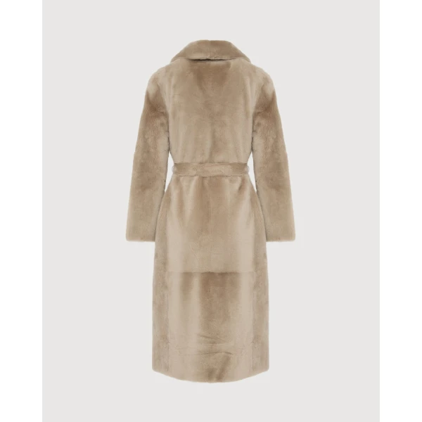Woman wearing Yves Salomon shearling fur coat – luxury outerwear at Coveti