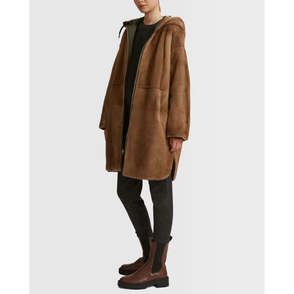 Woman wearing Yves Salomon shearling fur coat – luxury outerwear at Coveti