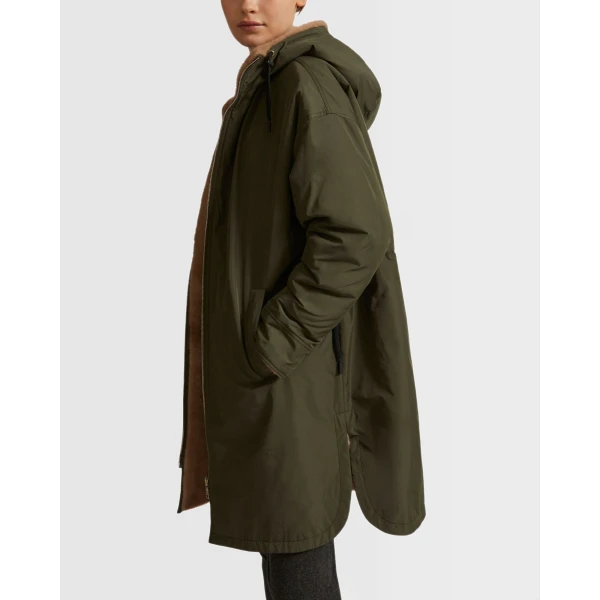 Woman wearing Yves Salomon shearling fur coat – luxury outerwear at Coveti