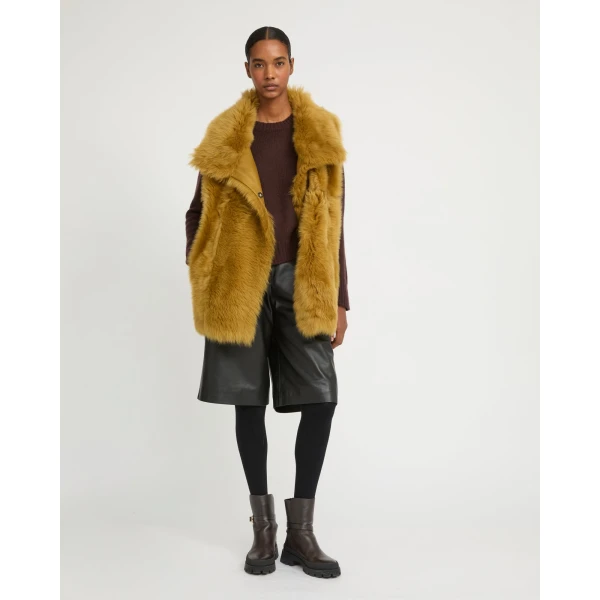 Woman wearing Yves Salomon shearling fur coat – luxury outerwear at Coveti