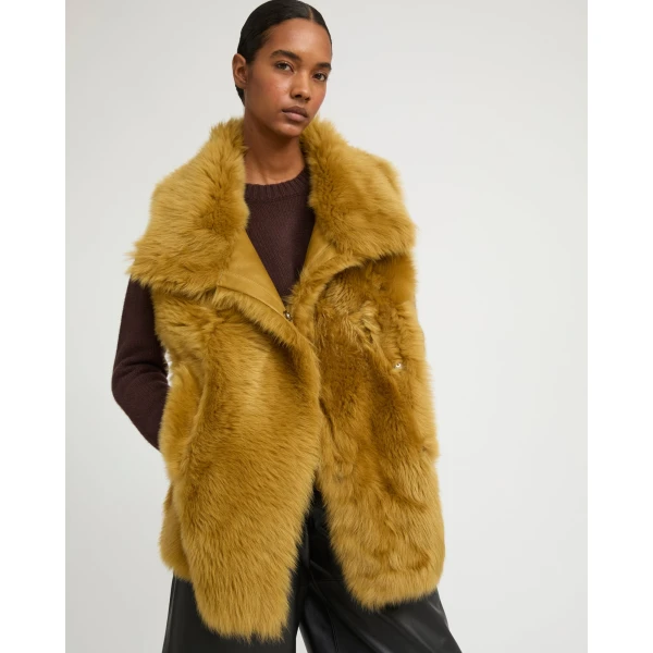 Woman wearing Yves Salomon shearling fur coat – luxury outerwear at Coveti