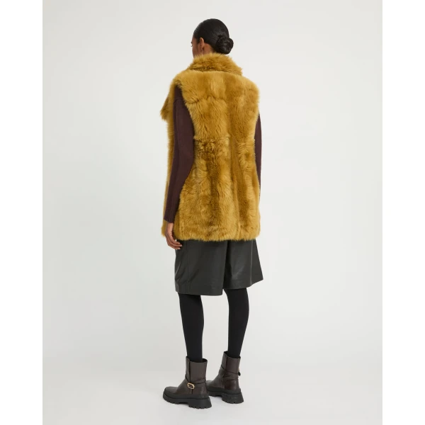 Woman wearing Yves Salomon shearling fur coat – luxury outerwear at Coveti