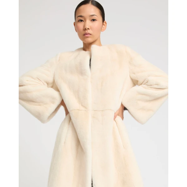 Woman wearing Yves Salomon shearling fur coat – luxury outerwear at Coveti