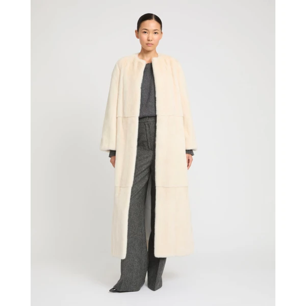 Woman wearing Yves Salomon shearling fur coat – luxury outerwear at Coveti