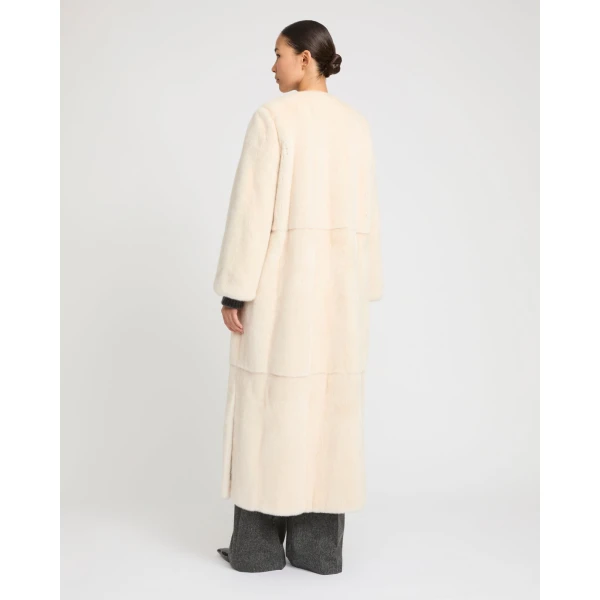 Woman wearing Yves Salomon shearling fur coat – luxury outerwear at Coveti
