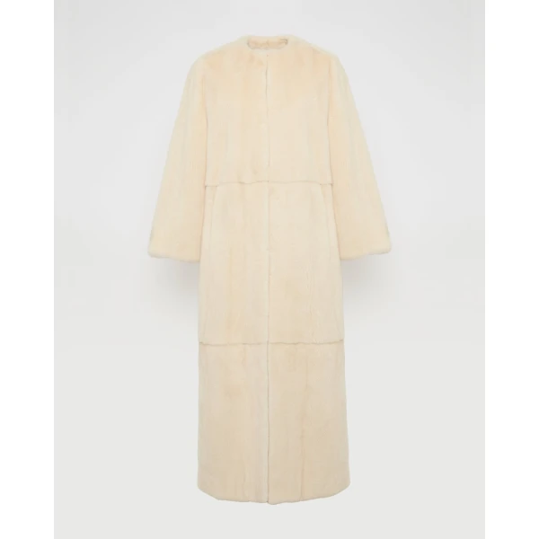 Woman wearing Yves Salomon shearling fur coat – luxury outerwear at Coveti
