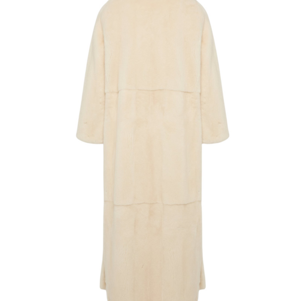 Woman wearing Yves Salomon shearling fur coat – luxury outerwear at Coveti