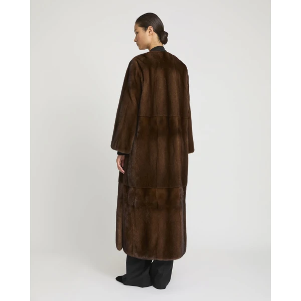 Woman wearing Yves Salomon shearling fur coat – luxury outerwear at Coveti