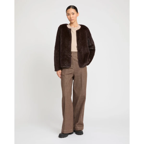 Woman wearing Yves Salomon shearling fur coat – luxury outerwear at Coveti