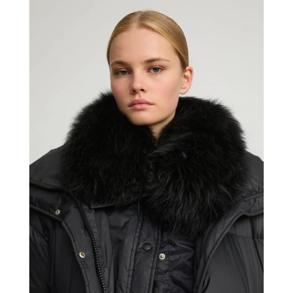 Woman wearing Yves Salomon shearling fur coat – luxury outerwear at Coveti