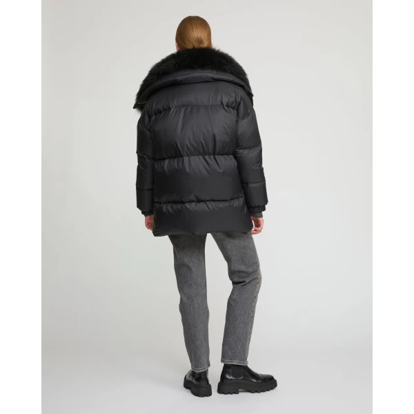 Woman wearing Yves Salomon shearling fur coat – luxury outerwear at Coveti
