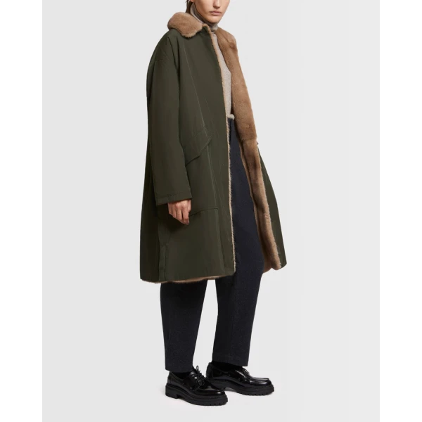 Woman wearing Yves Salomon shearling fur coat – luxury outerwear at Coveti