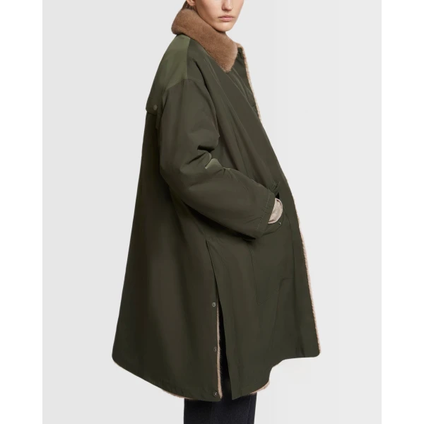 Woman wearing Yves Salomon shearling fur coat – luxury outerwear at Coveti