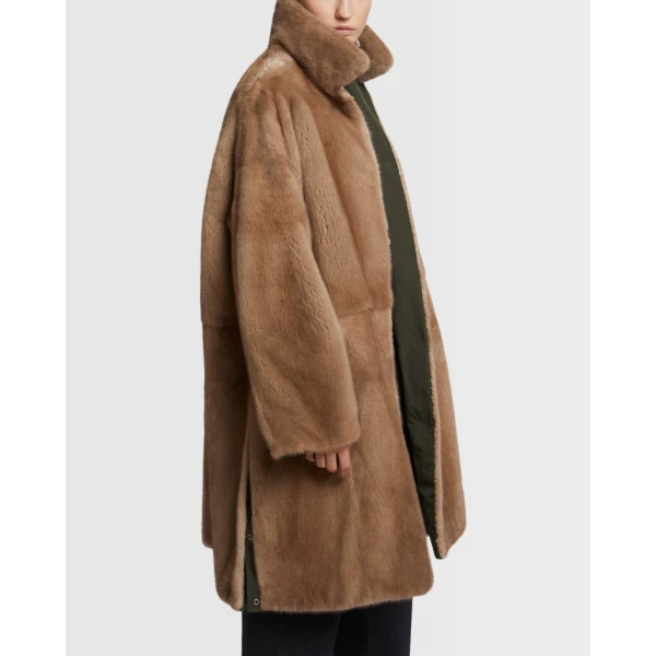 Woman wearing Yves Salomon shearling fur coat – luxury outerwear at Coveti