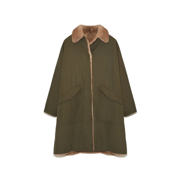 Woman wearing Yves Salomon shearling fur coat – luxury outerwear at Coveti