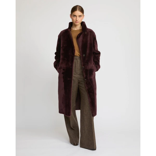 Woman wearing Yves Salomon shearling fur coat – luxury outerwear at Coveti