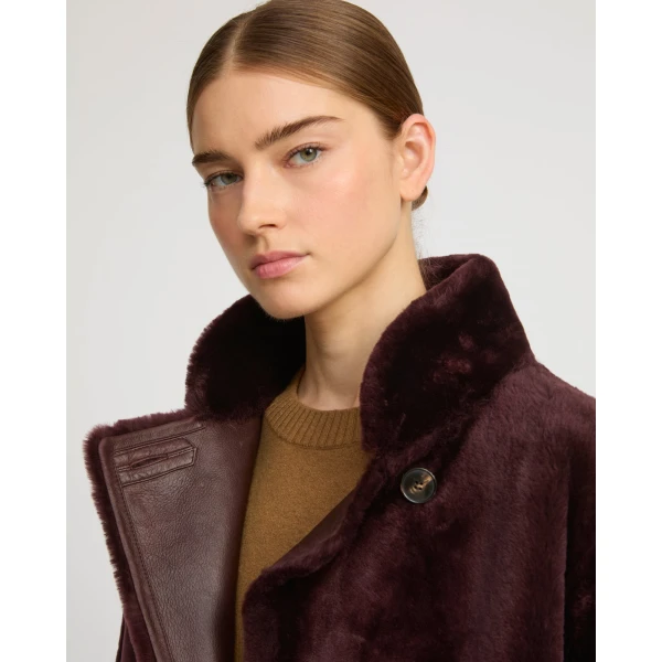 Woman wearing Yves Salomon shearling fur coat – luxury outerwear at Coveti