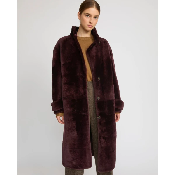 Woman wearing Yves Salomon shearling fur coat – luxury outerwear at Coveti