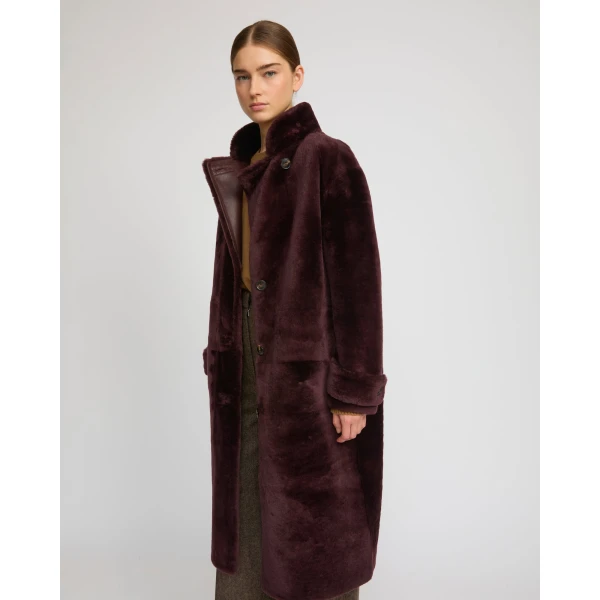 Woman wearing Yves Salomon shearling fur coat – luxury outerwear at Coveti