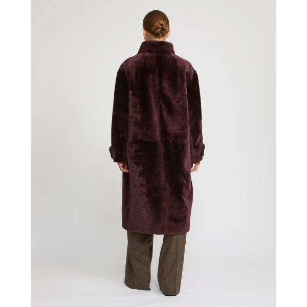 Woman wearing Yves Salomon shearling fur coat – luxury outerwear at Coveti