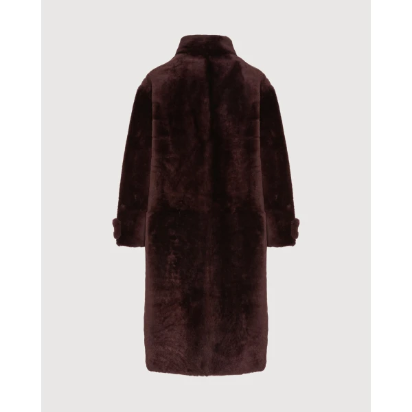 Woman wearing Yves Salomon shearling fur coat – luxury outerwear at Coveti