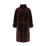 Woman wearing Yves Salomon shearling fur coat – luxury outerwear at Coveti