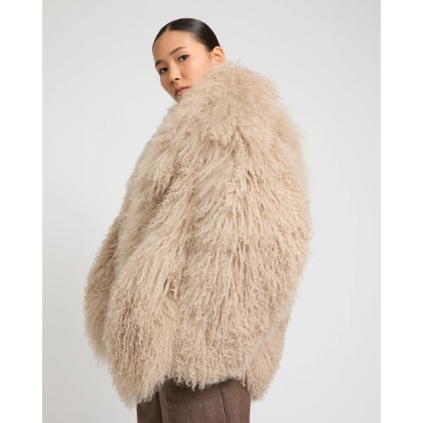Woman wearing Yves Salomon shearling fur coat – luxury outerwear at Coveti