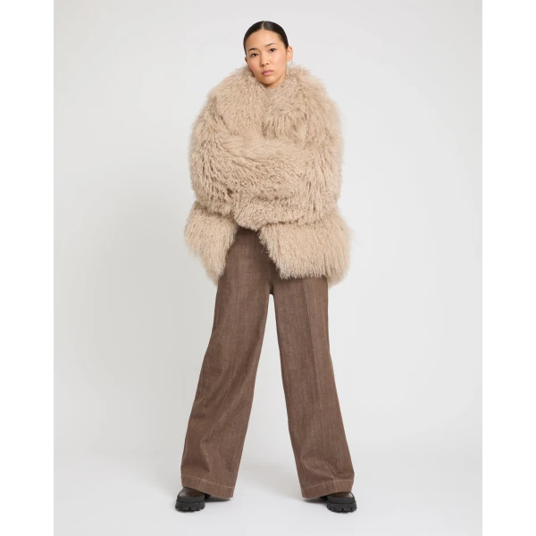 Woman wearing Yves Salomon shearling fur coat – luxury outerwear at Coveti