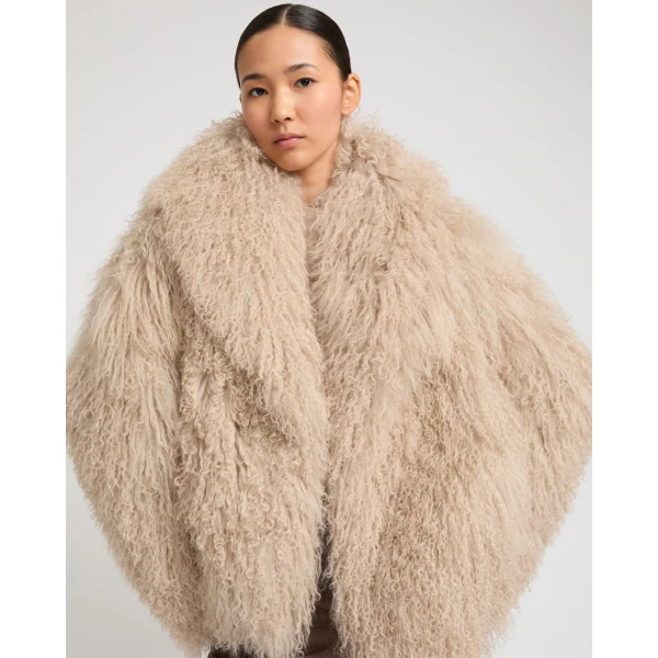 Woman wearing Yves Salomon shearling fur coat – luxury outerwear at Coveti