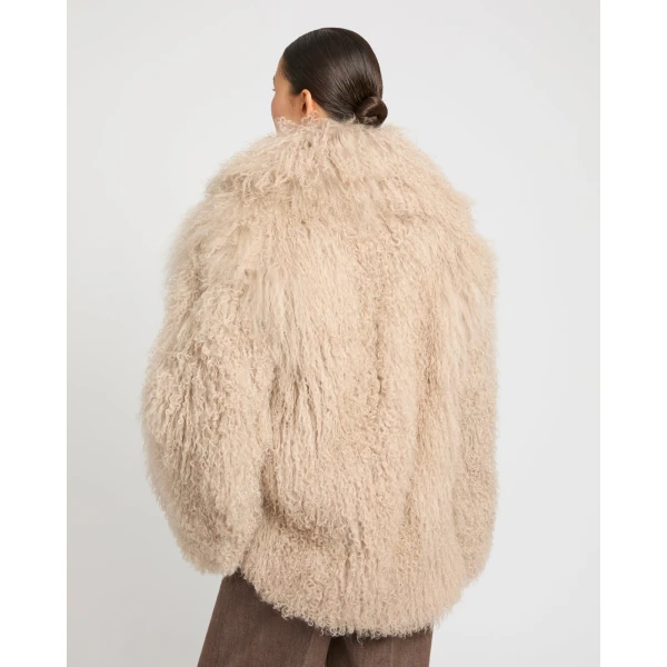 Woman wearing Yves Salomon shearling fur coat – luxury outerwear at Coveti