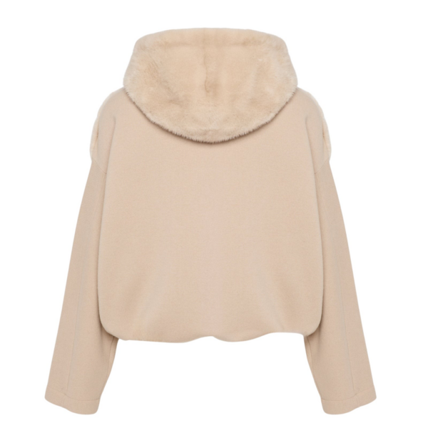 Woman wearing Yves Salomon shearling fur coat – luxury outerwear at Coveti