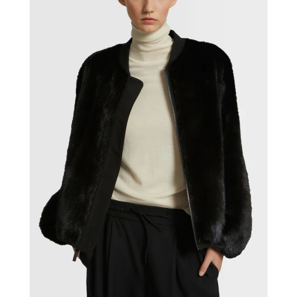 Woman wearing Yves Salomon shearling fur coat – luxury outerwear at Coveti
