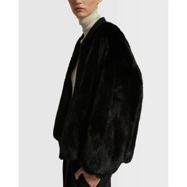 Woman wearing Yves Salomon shearling fur coat – luxury outerwear at Coveti