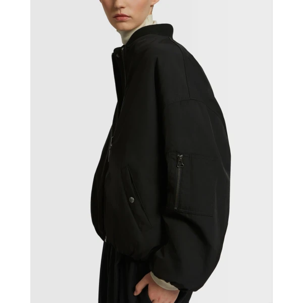 Woman wearing Yves Salomon shearling fur coat – luxury outerwear at Coveti