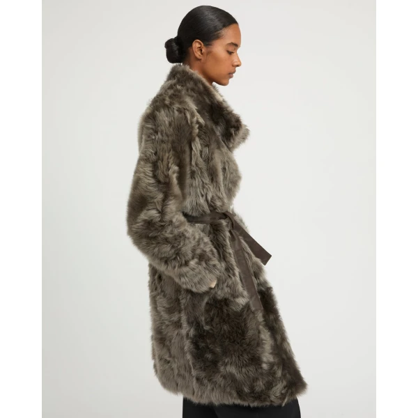 Woman wearing Yves Salomon shearling fur coat – luxury outerwear at Coveti