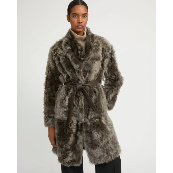 Woman wearing Yves Salomon shearling fur coat – luxury outerwear at Coveti