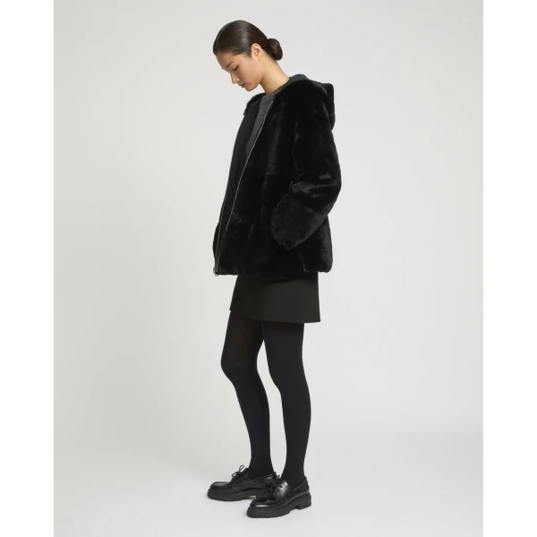 Woman wearing Yves Salomon shearling fur coat – luxury outerwear at Coveti
