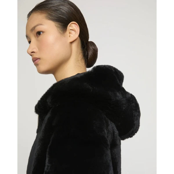 Woman wearing Yves Salomon shearling fur coat – luxury outerwear at Coveti