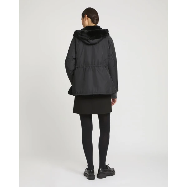 Woman wearing Yves Salomon shearling fur coat – luxury outerwear at Coveti