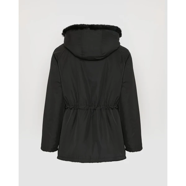 Woman wearing Yves Salomon shearling fur coat – luxury outerwear at Coveti