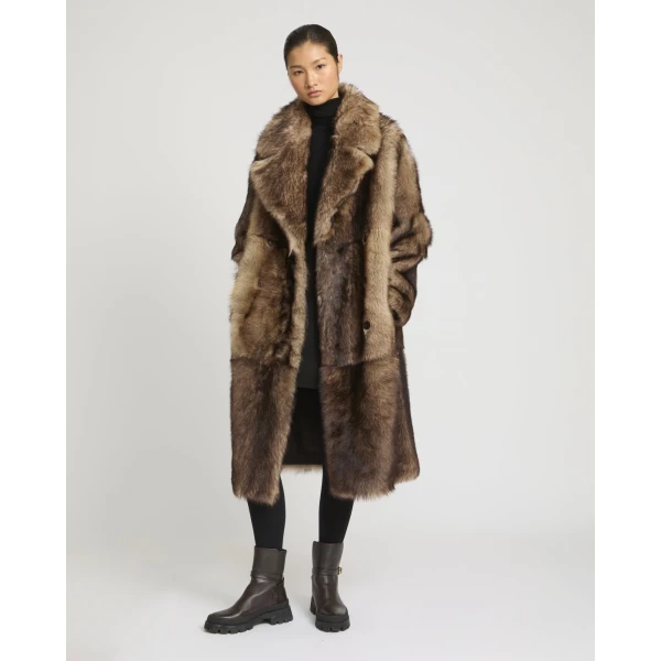Woman wearing Yves Salomon shearling fur coat – luxury outerwear at Coveti