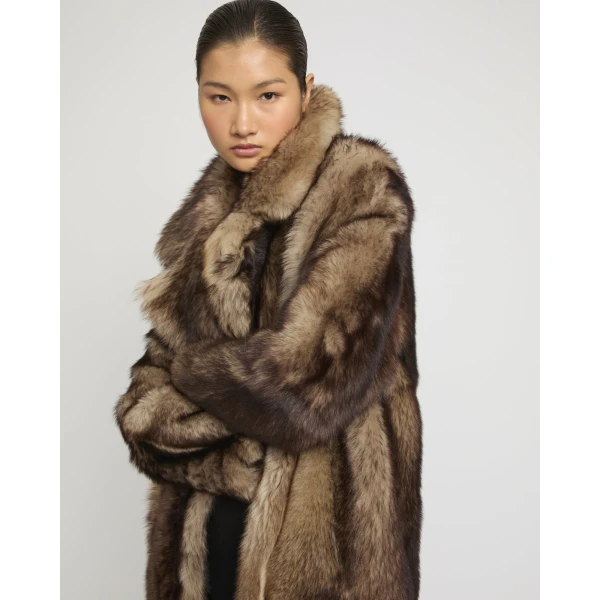 Woman wearing Yves Salomon shearling fur coat – luxury outerwear at Coveti