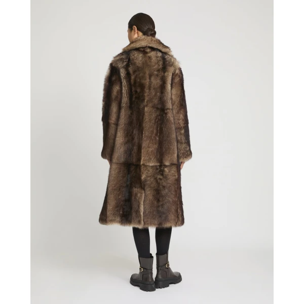 Woman wearing Yves Salomon shearling fur coat – luxury outerwear at Coveti