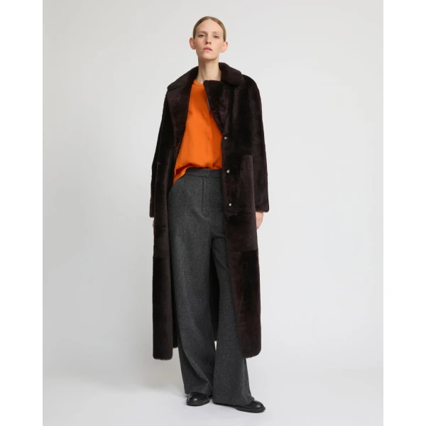 Woman wearing Yves Salomon shearling fur coat – luxury outerwear at Coveti